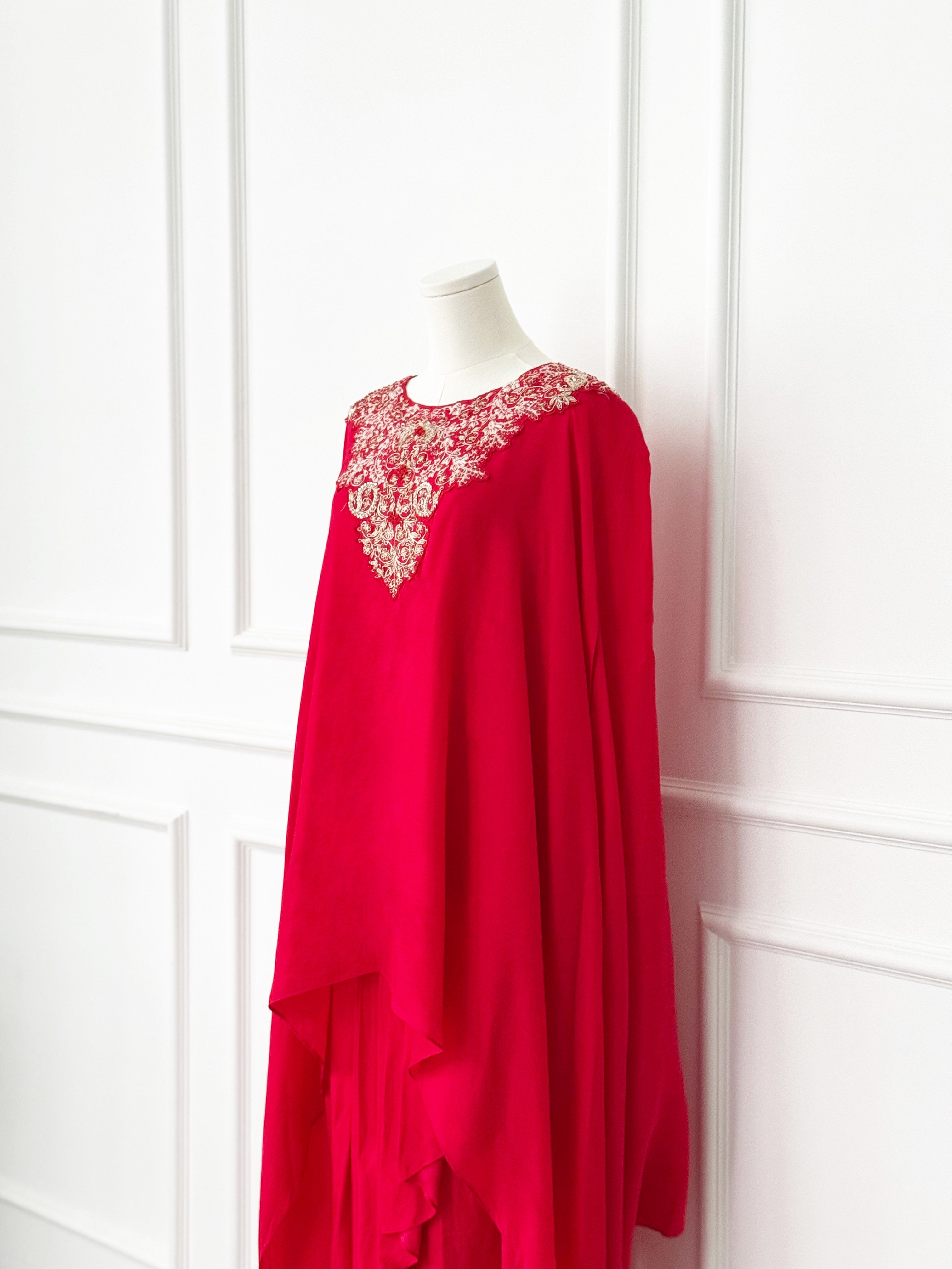 Red kaftan-style dress with intricate floral embroidery on the neckline and a flowing asymmetrical layered design, ideal for festive and formal occasions